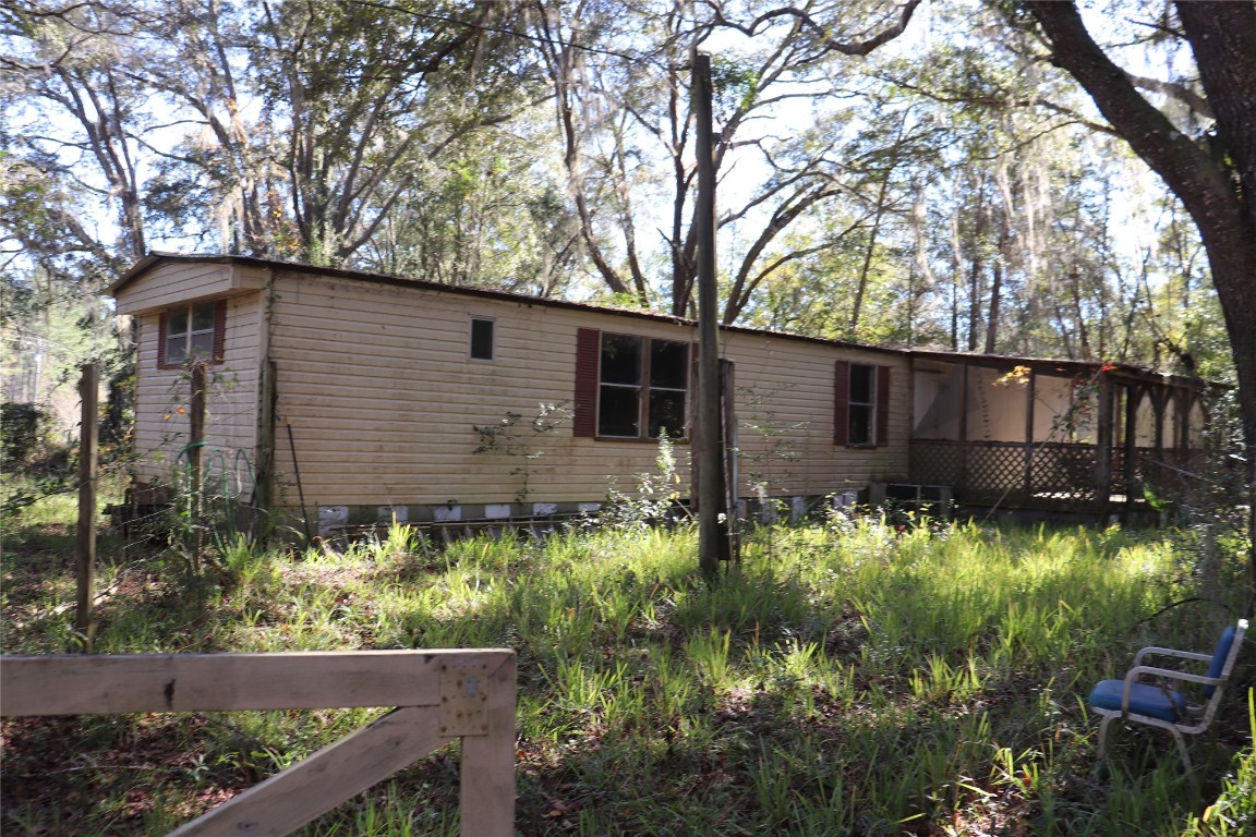574154 Lessie Road Hilliard, FL 32046 - Photo 18 of 34 a backyard of a house with lots of green space