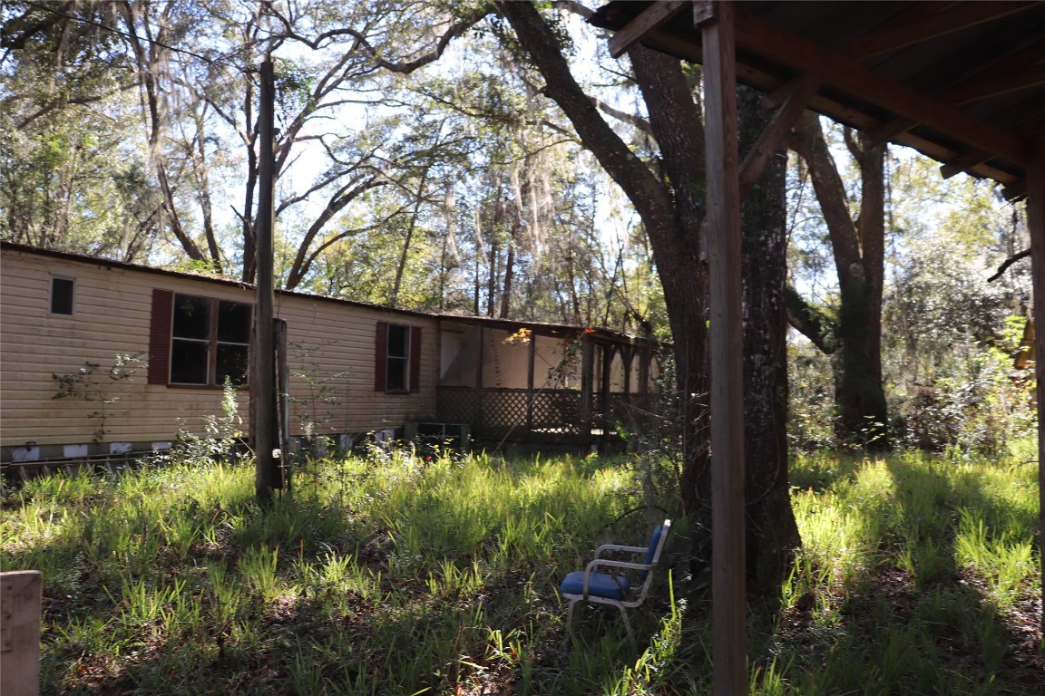 574154 Lessie Road Hilliard, FL 32046 - Photo 19 of 34 a backyard of a house with lots of green space