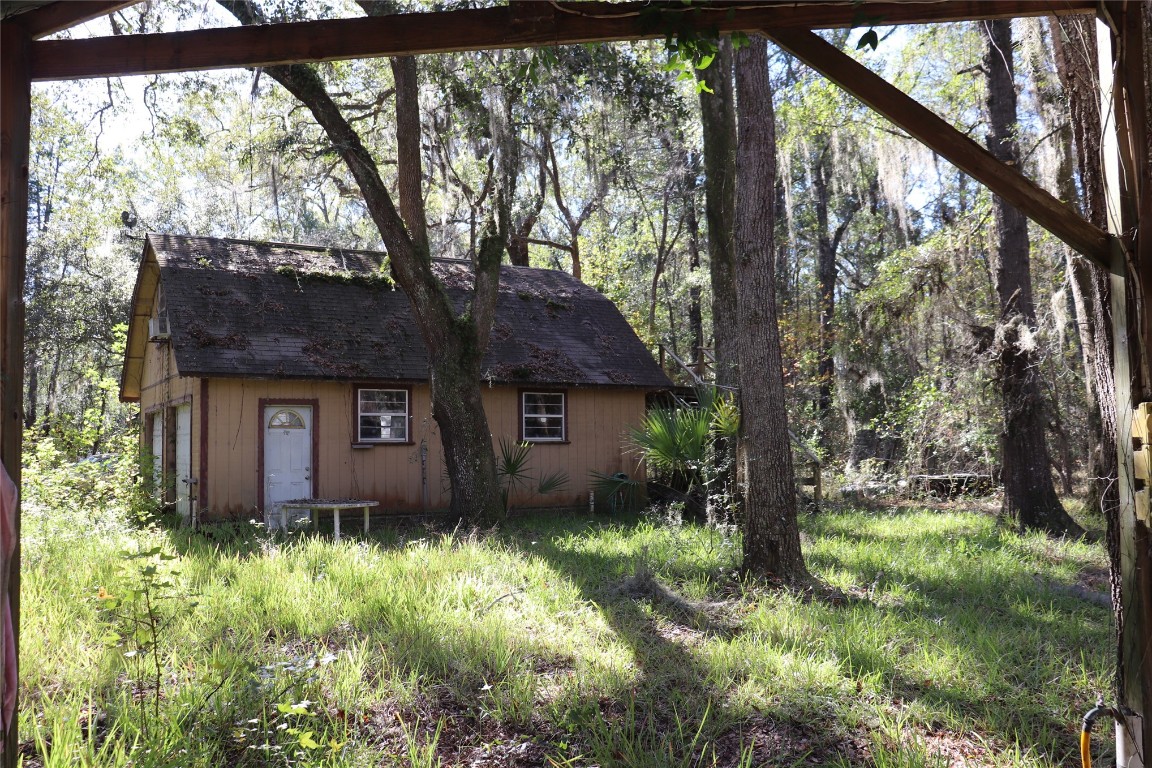 574154 Lessie Road Hilliard, FL 32046 - Photo 20 of 34 a view of a house with a tree in the yard