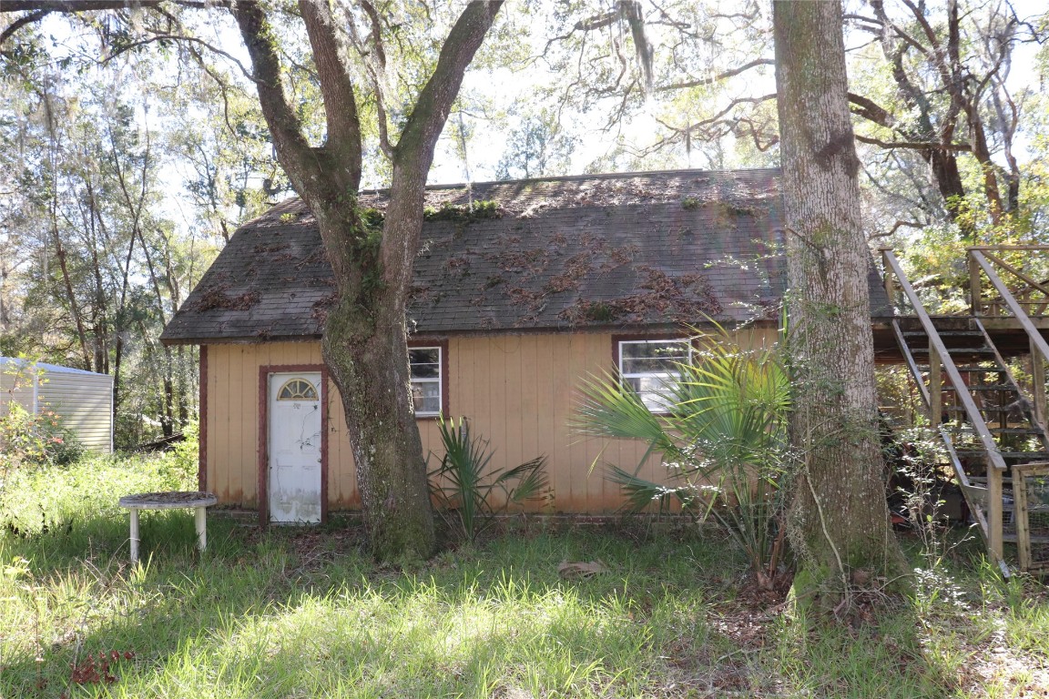 574154 Lessie Road Hilliard, FL 32046 - Photo 24 of 34 a backyard of a house with lots of green space