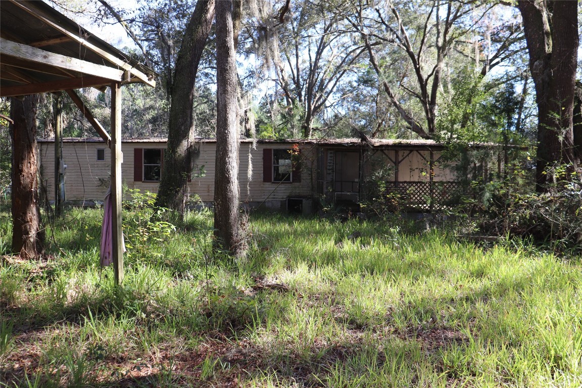 574154 Lessie Road Hilliard, FL 32046 - Photo 25 of 34 a backyard of a house with lots of green space