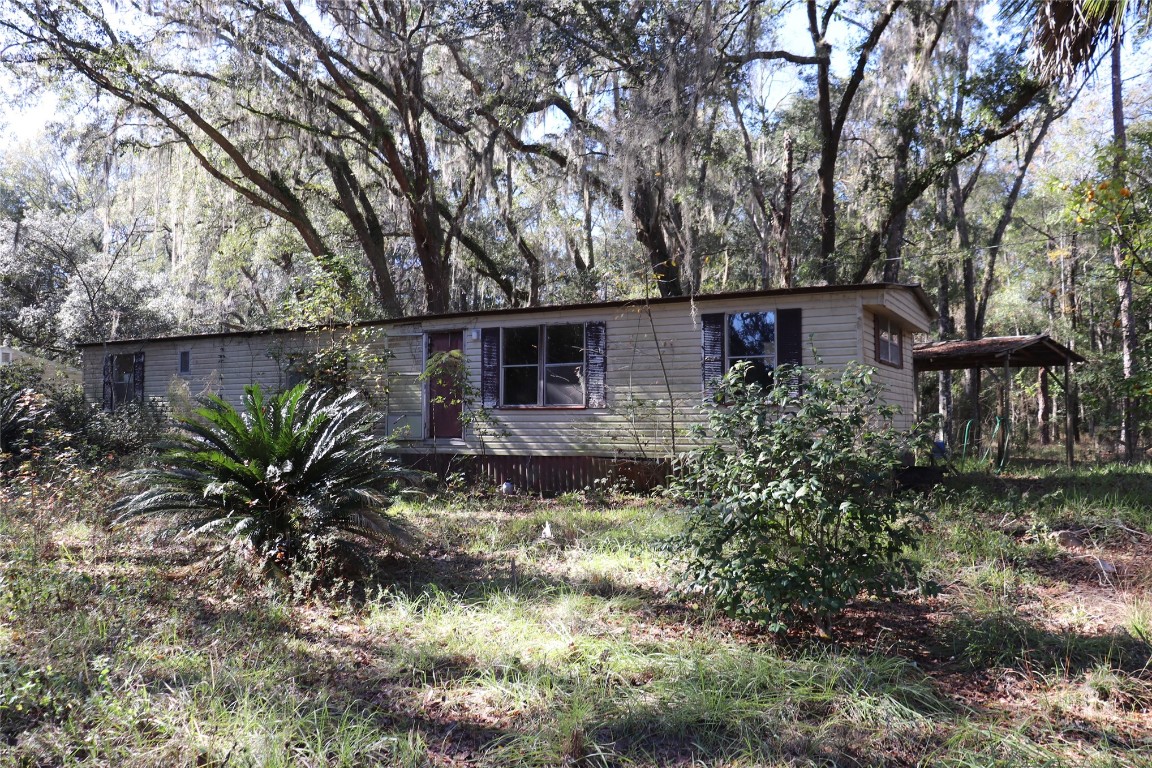 574154 Lessie Road Hilliard, FL 32046 - Photo 26 of 34 a view of a house with a yard