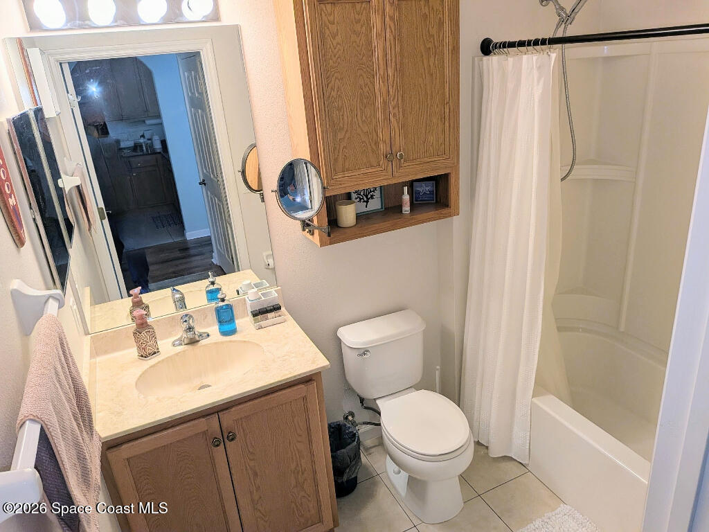 4530 Radiant Way, Unit 101 Melbourne, FL 32901 - Photo 11 of 26 a bathroom with a sink a toilet and shower