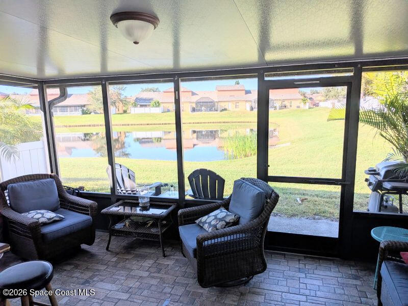 4530 Radiant Way, Unit 101 Melbourne, FL 32901 - Photo 17 of 26 a living room with patio couch and a large window