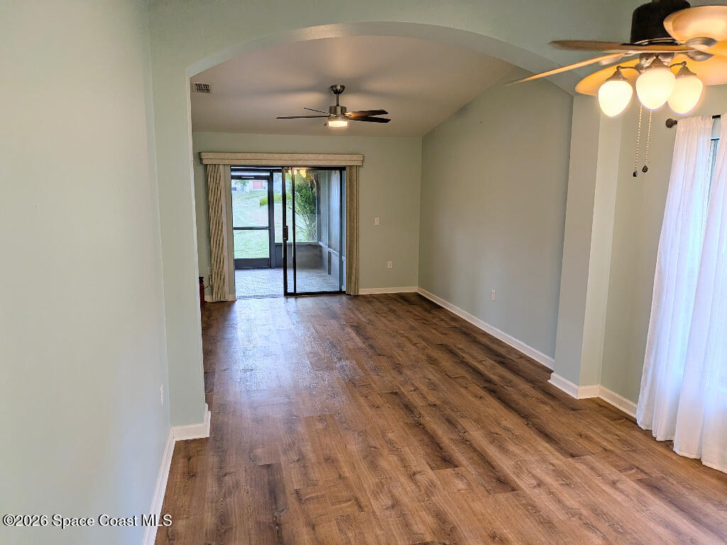 4530 Radiant Way, Unit 101 Melbourne, FL 32901 - Photo 24 of 26 a view of an empty room with wooden floor and a window