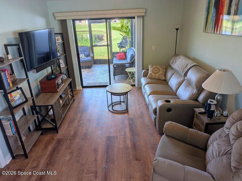 4530 Radiant Way, Unit 101 Melbourne, FL 32901 - Photo 3 of 26 a living room with furniture a window and a flat screen tv