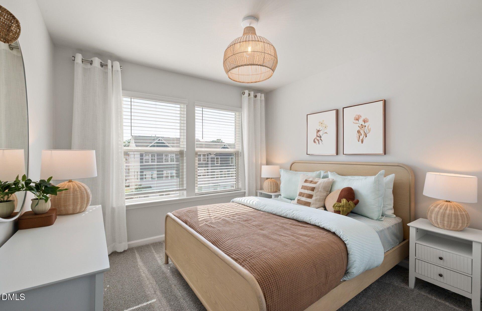 2544 Olive Chapel Road Apex, NC 27502 - Photo 15 of 32 a bedroom with a bed and a chandelier