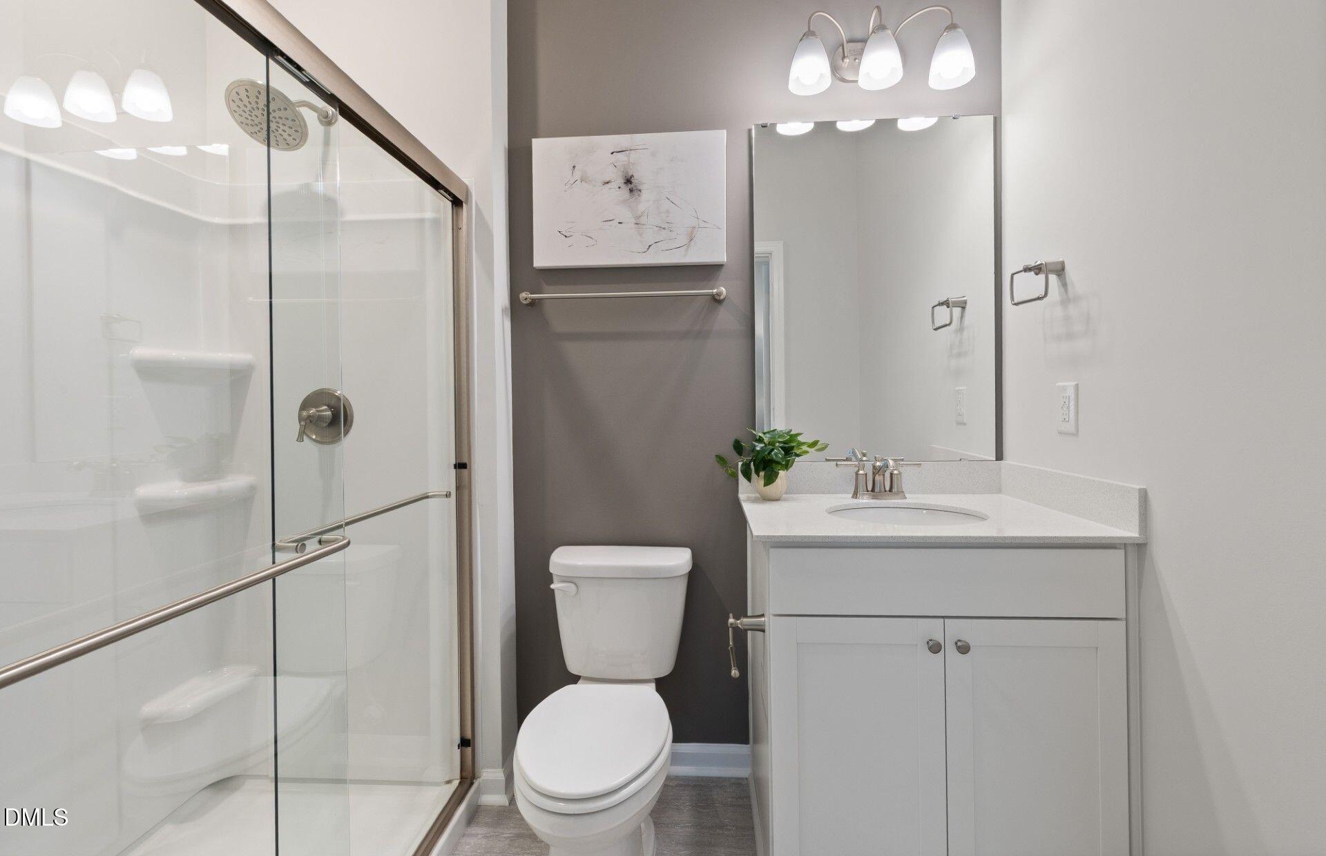 2544 Olive Chapel Road Apex, NC 27502 - Photo 19 of 32 a bathroom with a toilet sink and shower