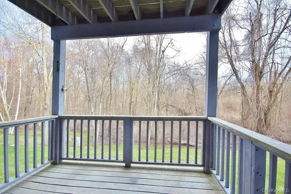 a view of balcony with wooden floor and fence