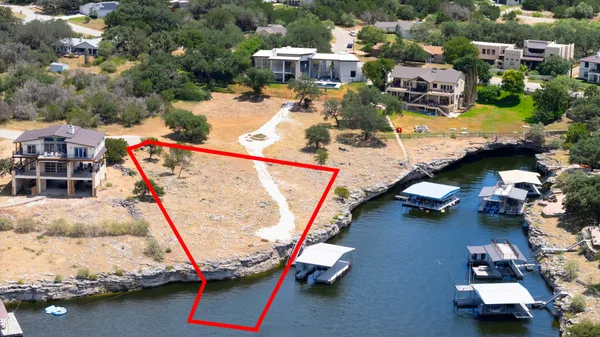 an aerial view of a house with a swimming pool patio and lake view