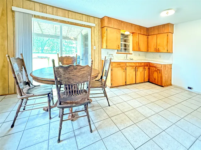 a kitchen with a table chairs and a dining table