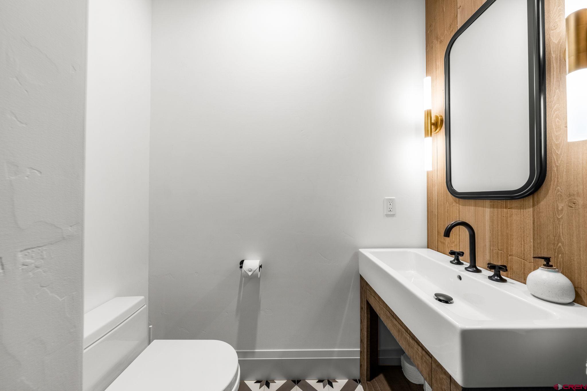49 Bluff Drive Durango, CO 81301 - Photo 28 of 45 a bathroom with a toilet a sink and mirror