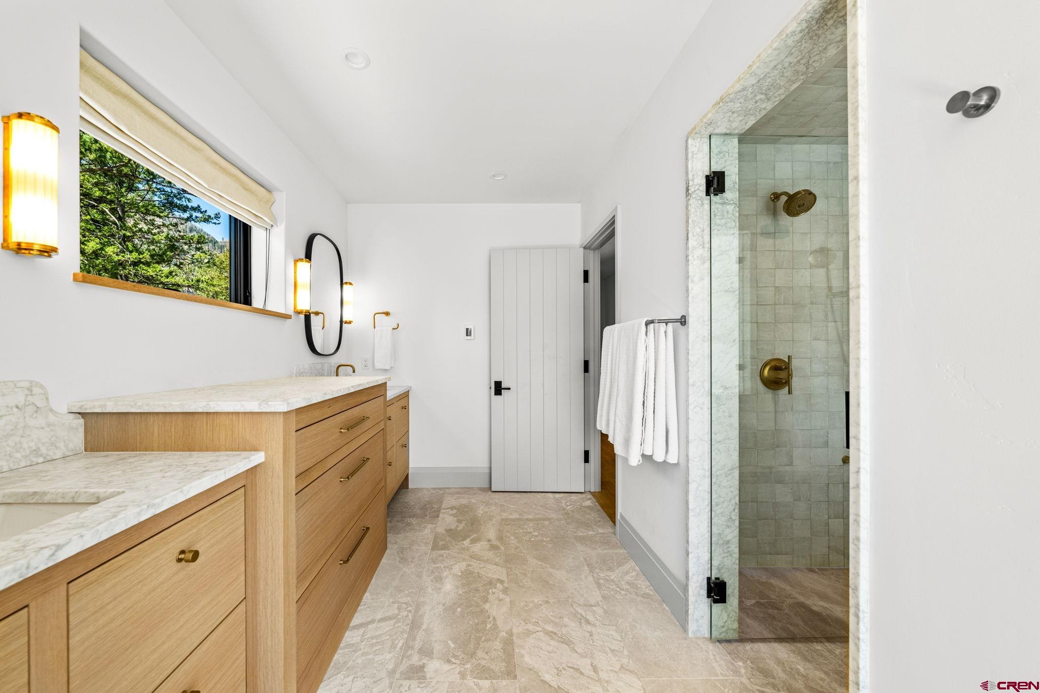 49 Bluff Drive Durango, CO 81301 - Photo 31 of 45 a bathroom with a granite countertop sink a mirror and shower