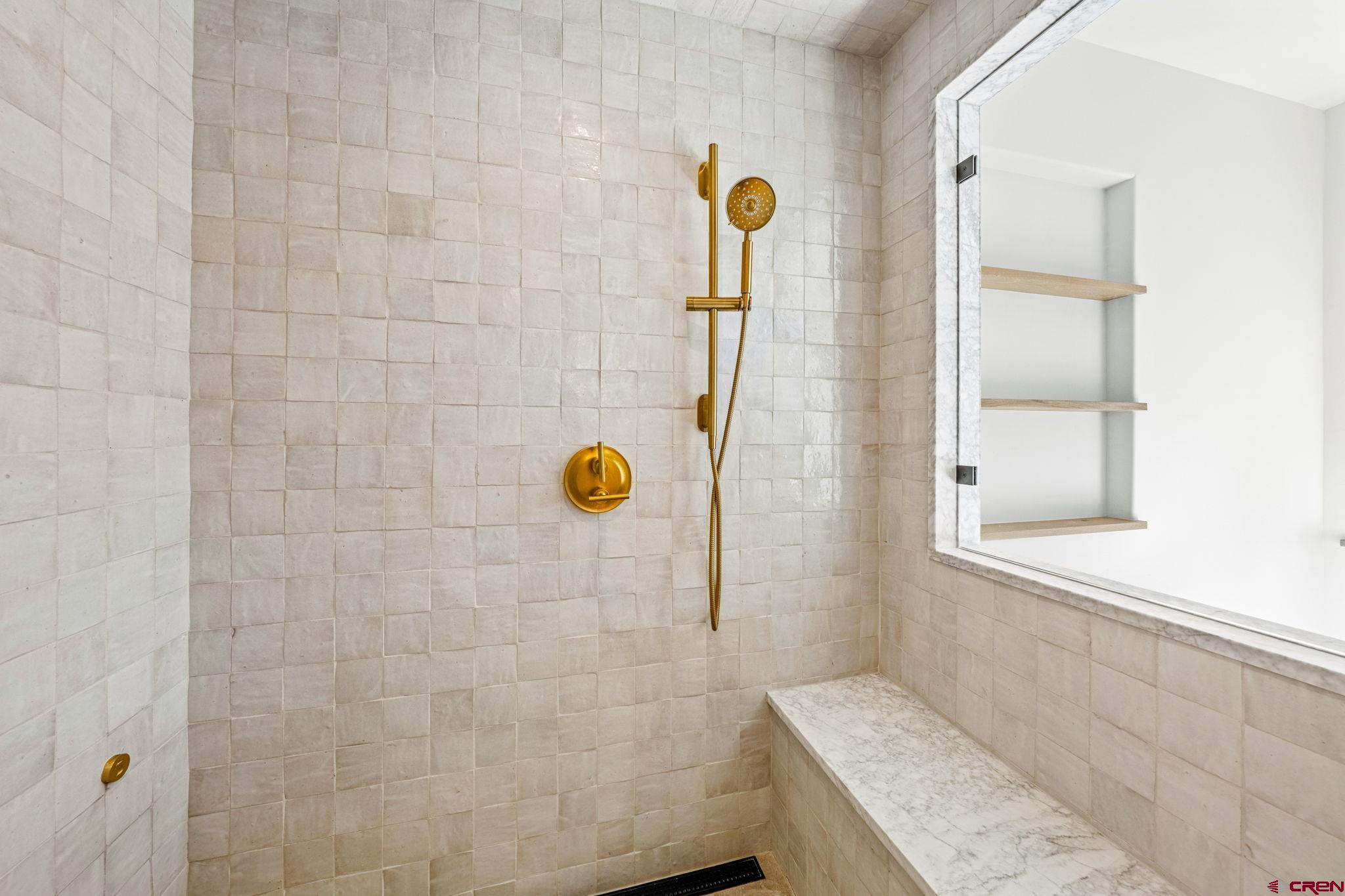 49 Bluff Drive Durango, CO 81301 - Photo 32 of 45 a bathroom with a granite countertop sink and a shower