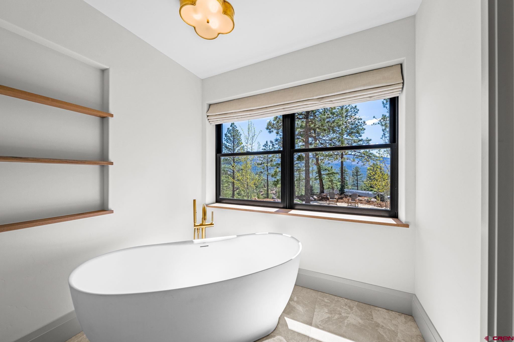 49 Bluff Drive Durango, CO 81301 - Photo 33 of 45 a white bath tub sitting next to a window