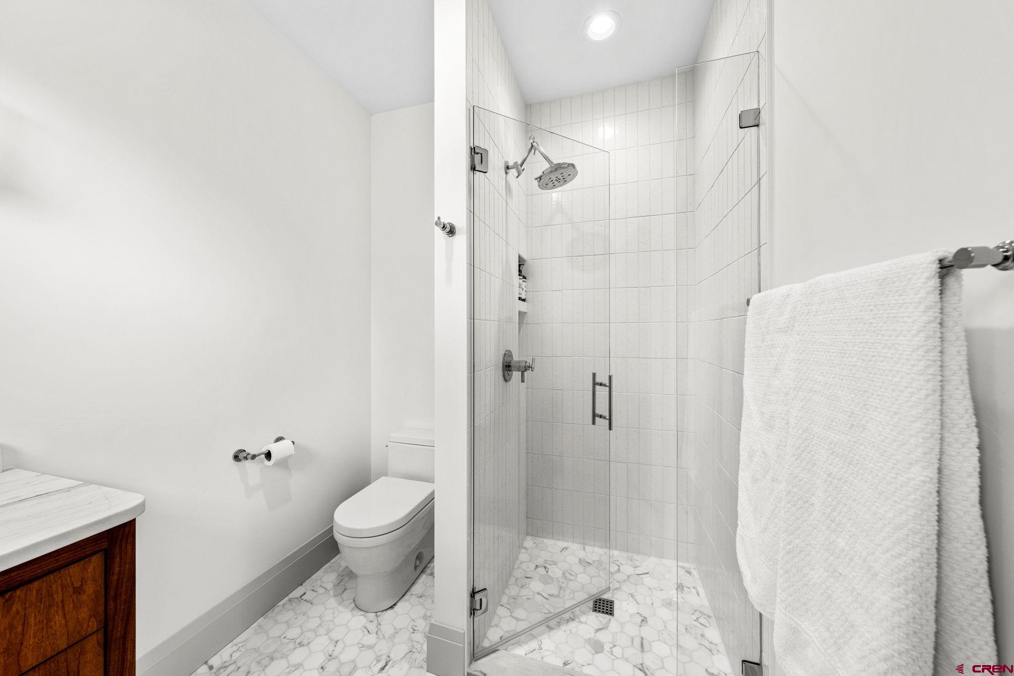 49 Bluff Drive Durango, CO 81301 - Photo 36 of 45 a bathroom with a granite countertop sink a toilet and shower