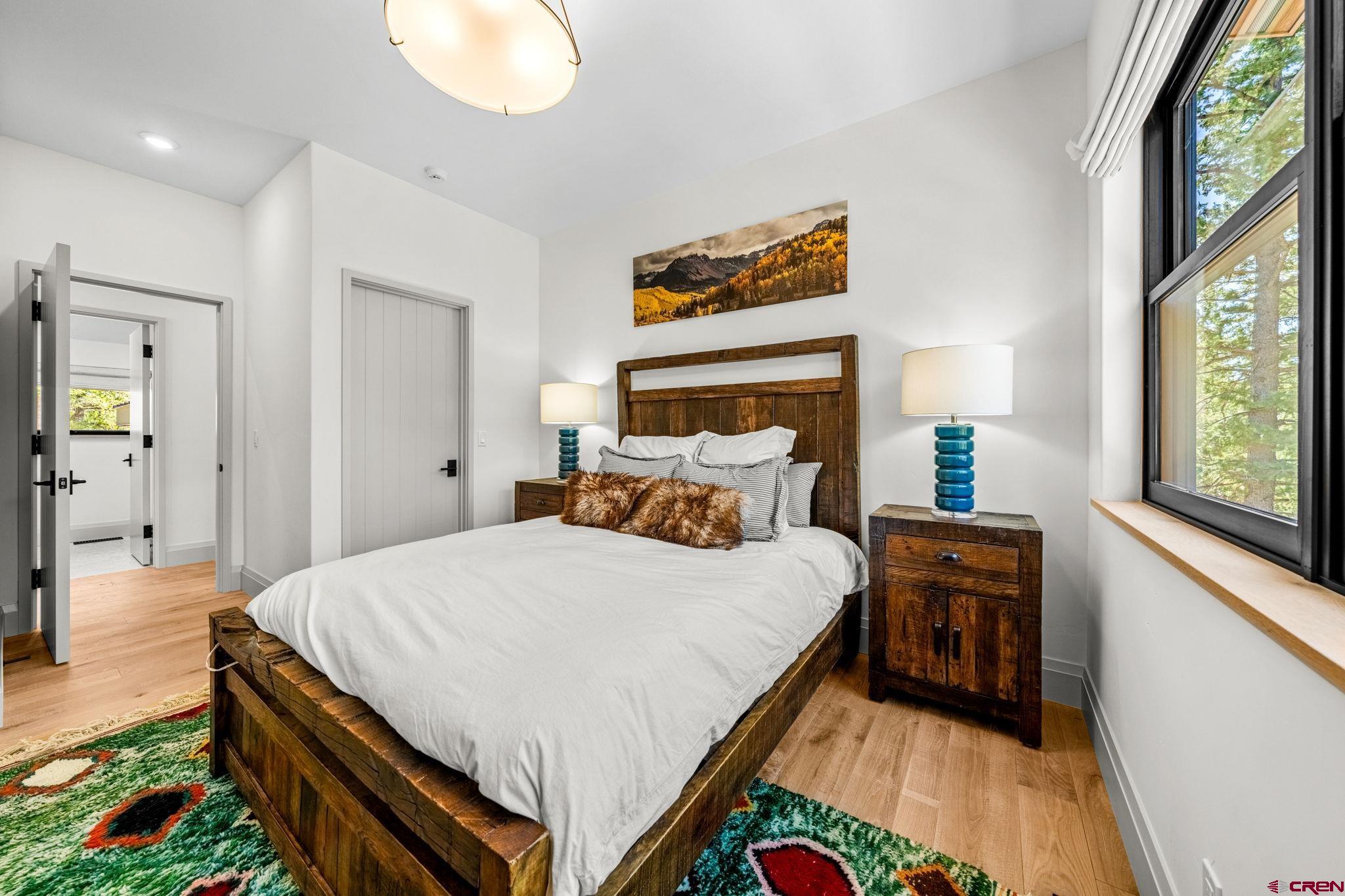 49 Bluff Drive Durango, CO 81301 - Photo 39 of 45 a bedroom with a bed and a painting on the wall