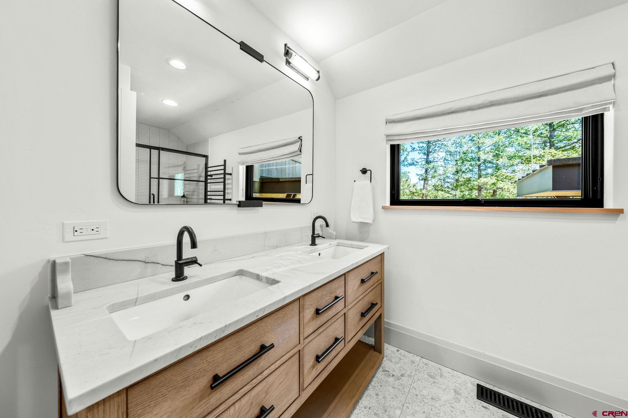 49 Bluff Drive Durango, CO 81301 - Photo 40 of 45 a bathroom with a double vanity sink and mirror