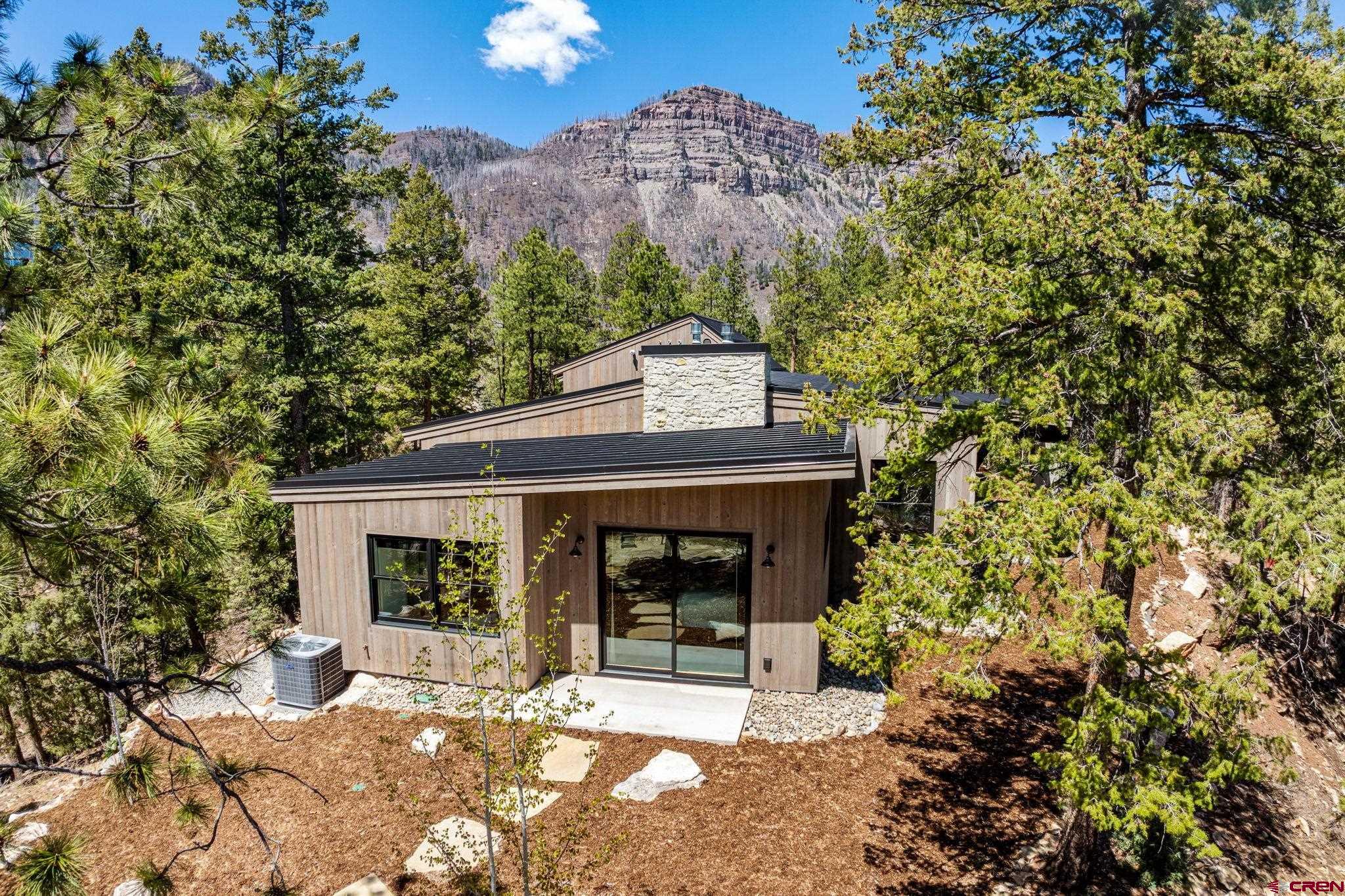 49 Bluff Drive Durango, CO 81301 - Photo 6 of 45 a front view of a house with a garden and yard