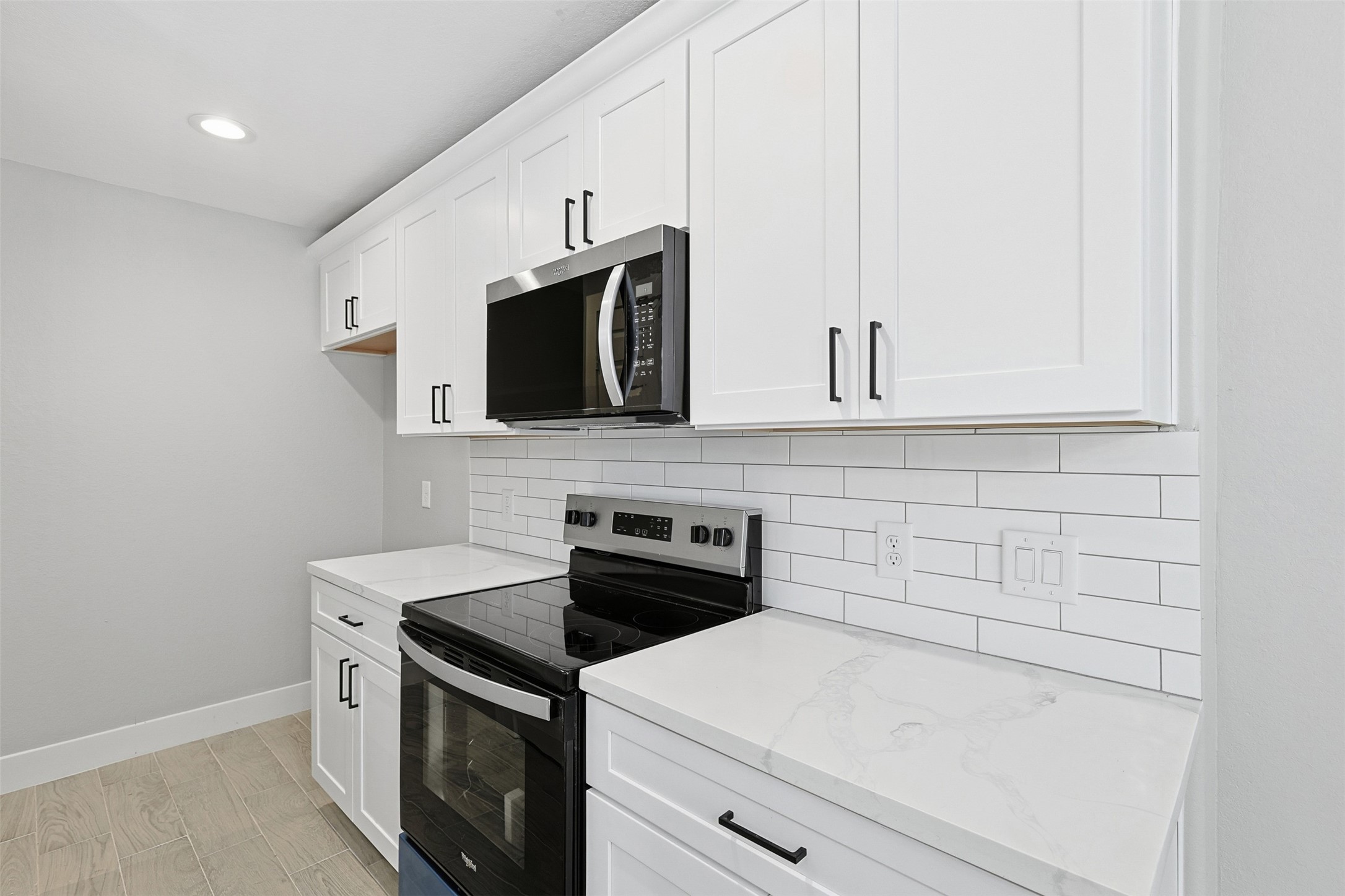 9718 Fillmore Street Houston, TX 77029 - Photo 11 of 30 a view of a kitchen with microwave and cabinets