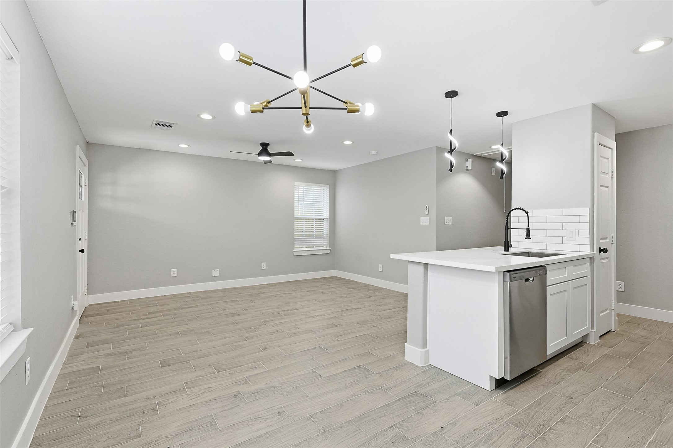 9718 Fillmore Street Houston, TX 77029 - Photo 13 of 30 a kitchen with stainless steel appliances granite countertop a white stove top oven and cabinets