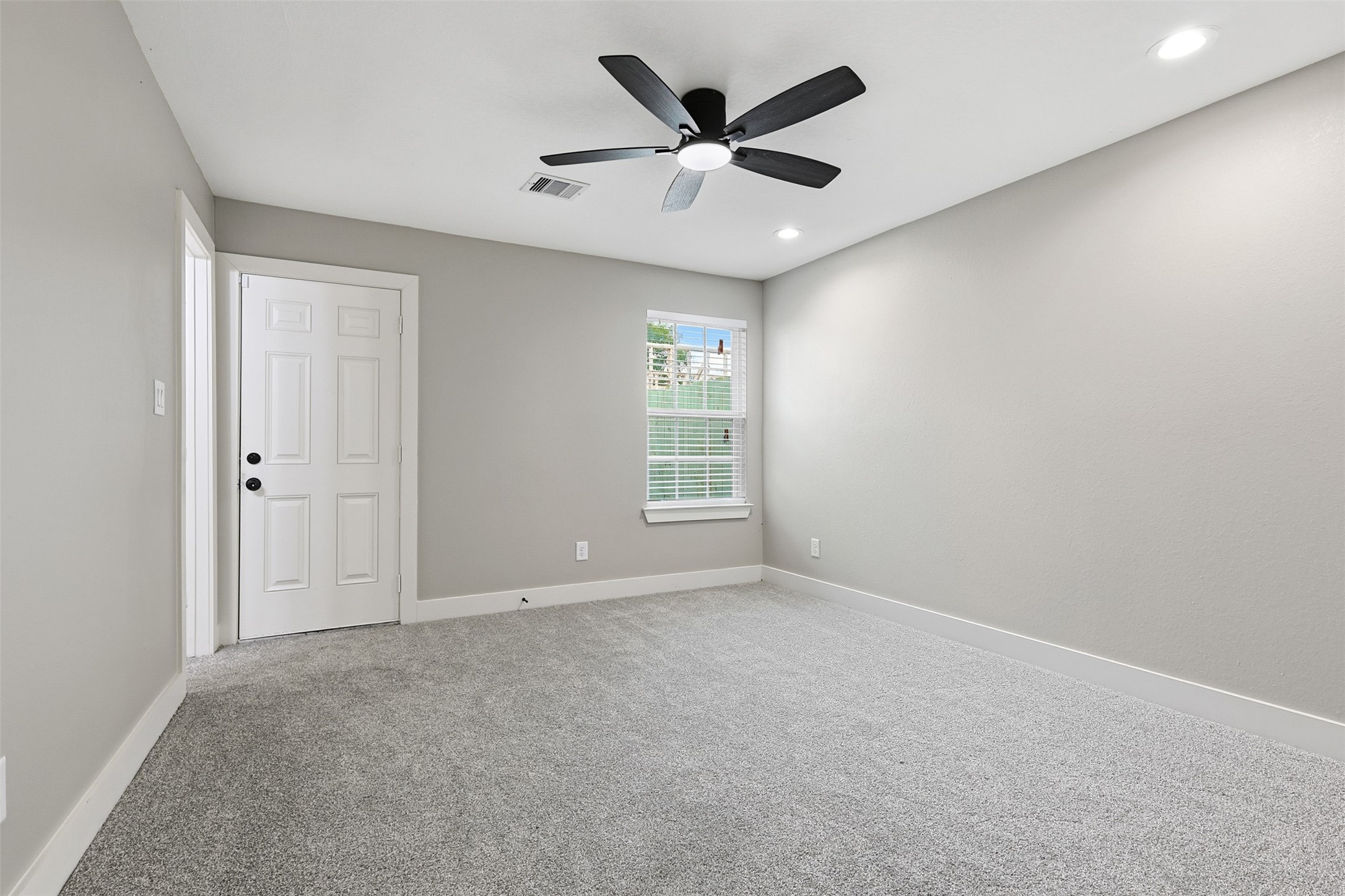 9718 Fillmore Street Houston, TX 77029 - Photo 15 of 30 an empty room with a ceiling fan and window