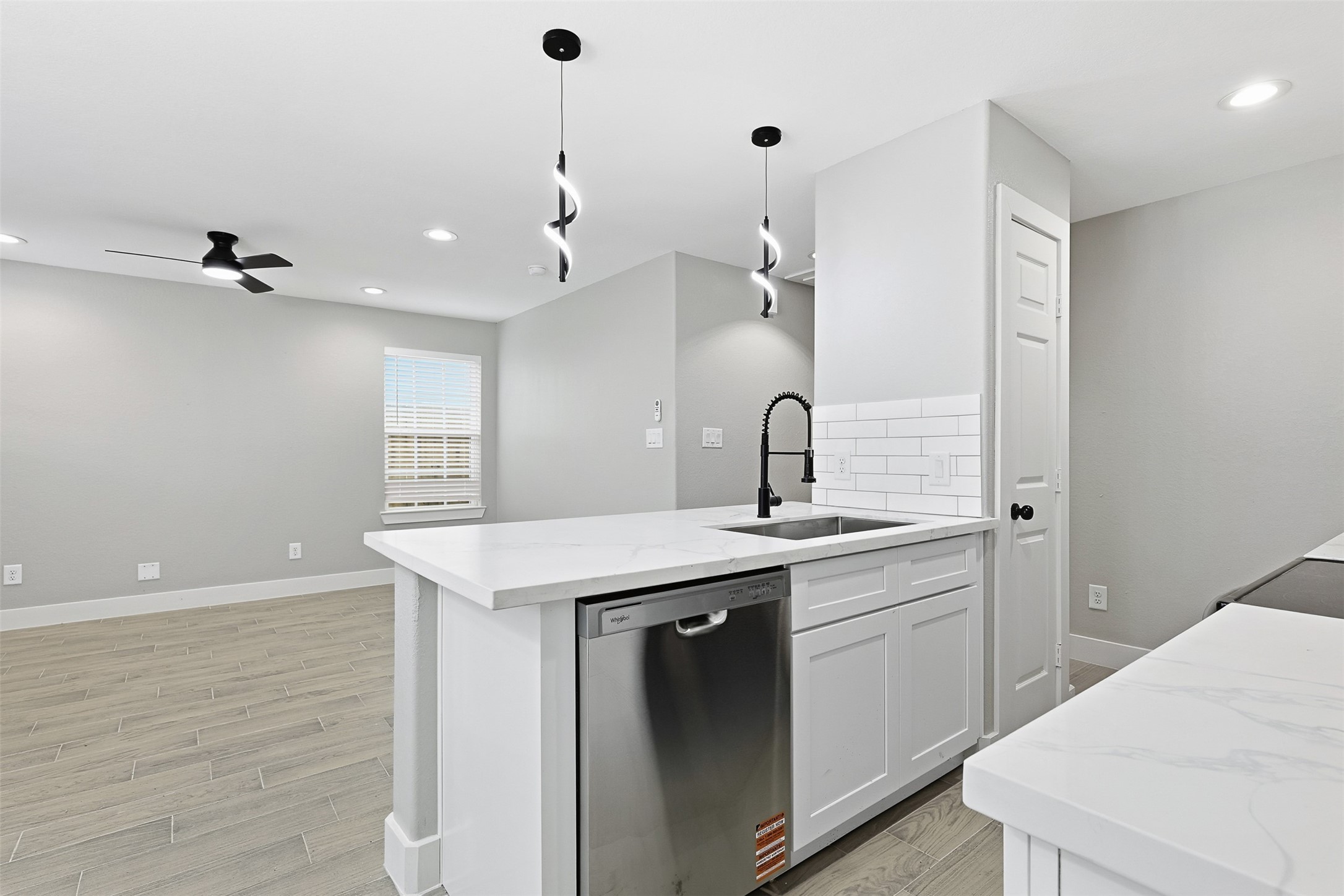 9718 Fillmore Street Houston, TX 77029 - Photo 9 of 30 a kitchen with a sink a stove cabinets and wooden floor