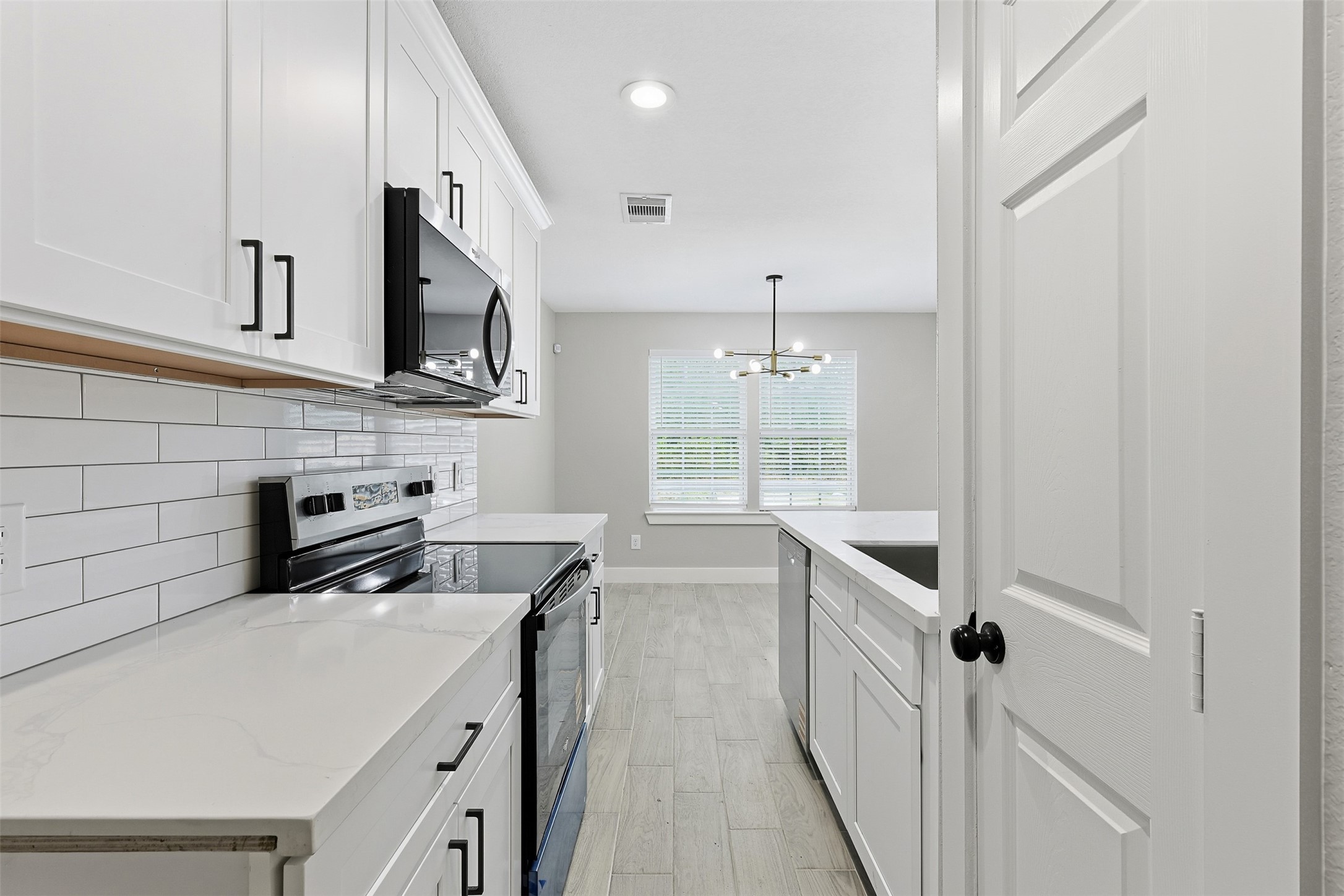 9718 Fillmore Street Houston, TX 77029 - Photo 10 of 30 a kitchen with a sink a stove oven and cabinets