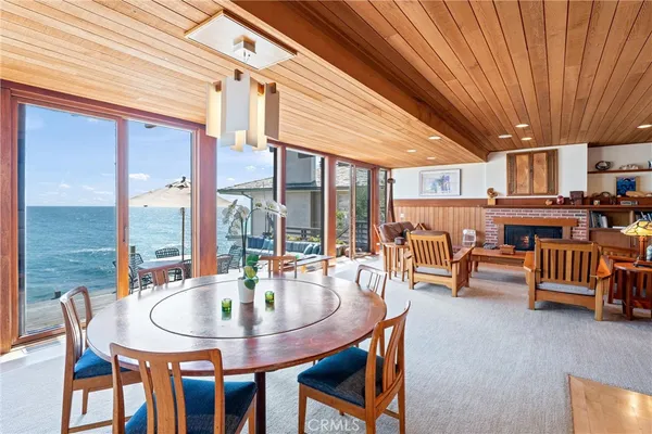 a dining room with furniture and a floor to ceiling window