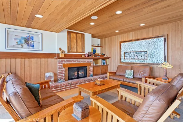 a living room with furniture a large window and a fireplace