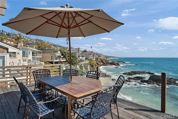 a view of a terrace with furniture and umbrella