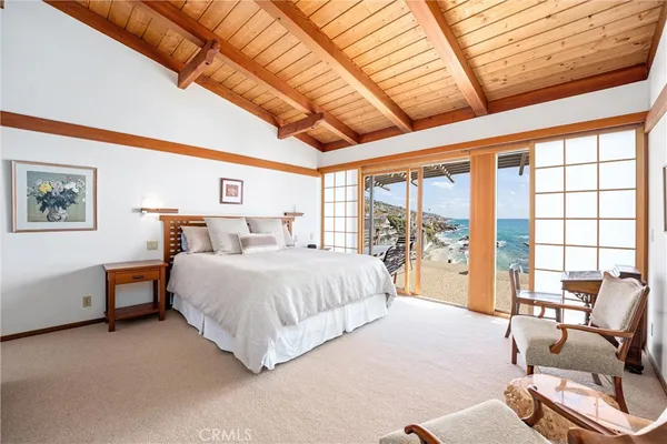 a bedroom with a large bed and a large window