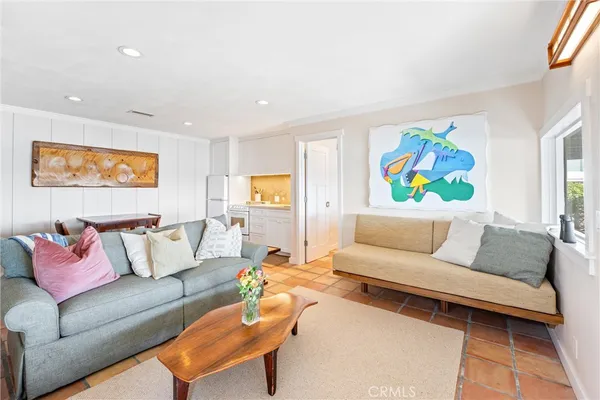 a living room with furniture and wall painting