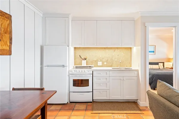 a kitchen with stainless steel appliances granite countertop a sink and a refrigerator