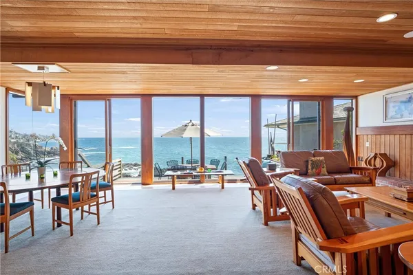 a very nice looking living room with a large window and a table