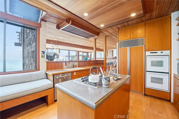 a kitchen with a sink appliances and cabinets