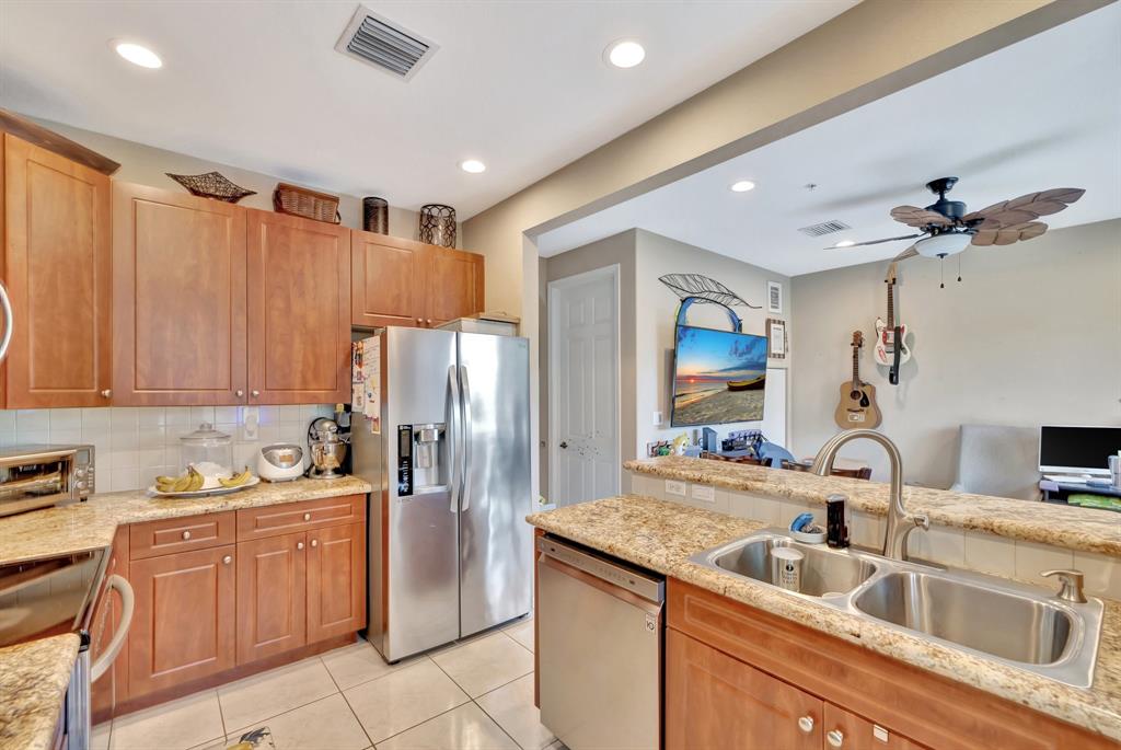 2851 Prospect Road, Unit 1209 Tamarac, FL 33309 - Photo 18 of 59 a kitchen with a sink refrigerator and cabinets