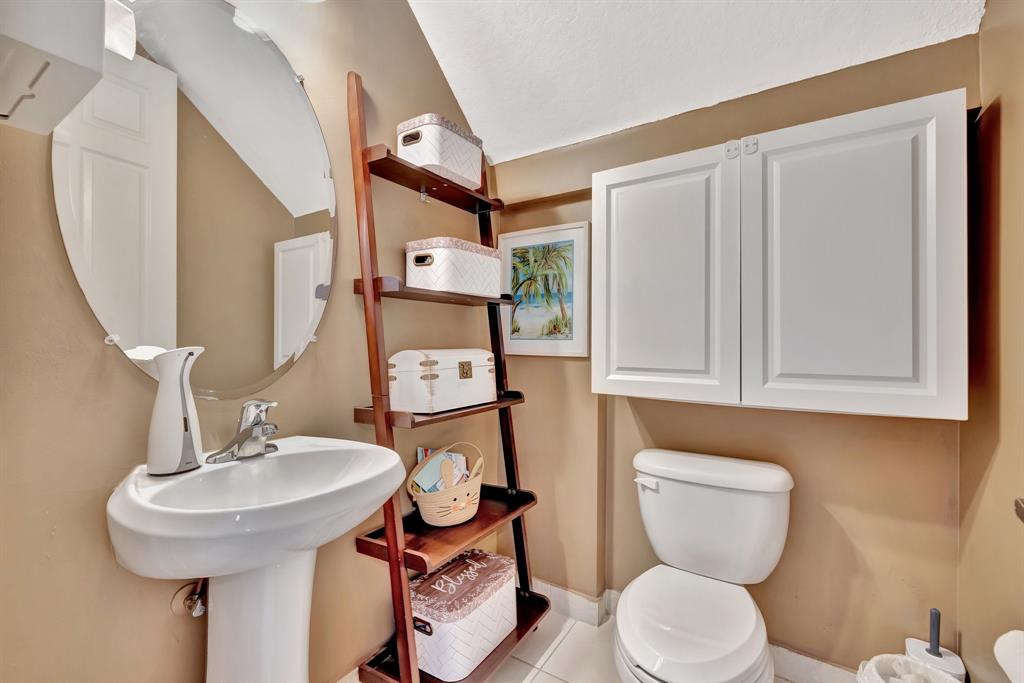2851 Prospect Road, Unit 1209 Tamarac, FL 33309 - Photo 20 of 59 a bathroom with a toilet sink and mirror