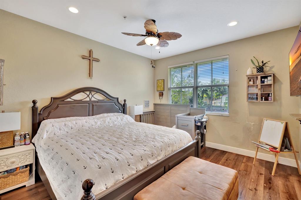 2851 Prospect Road, Unit 1209 Tamarac, FL 33309 - Photo 24 of 59 a bedroom with a bed and a chair