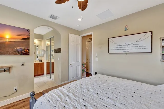 a bedroom with a bed dresser and a window