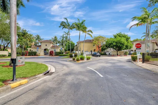 an aerial view of lake and residential houses with outdoor space and swimming pool