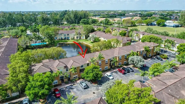a front view of a house with a garden and yard