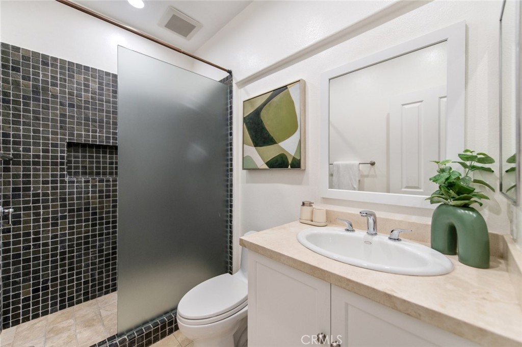 12 Parthenia Irvine, CA 92606 - Photo 17 of 25 a bathroom with a granite countertop sink a toilet and mirror