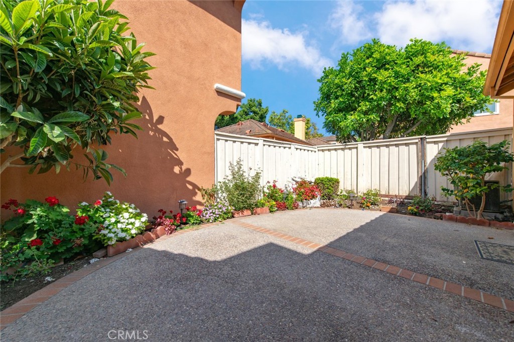 12 Parthenia Irvine, CA 92606 - Photo 18 of 25 a wooden bench sitting in front of a house with potted plants