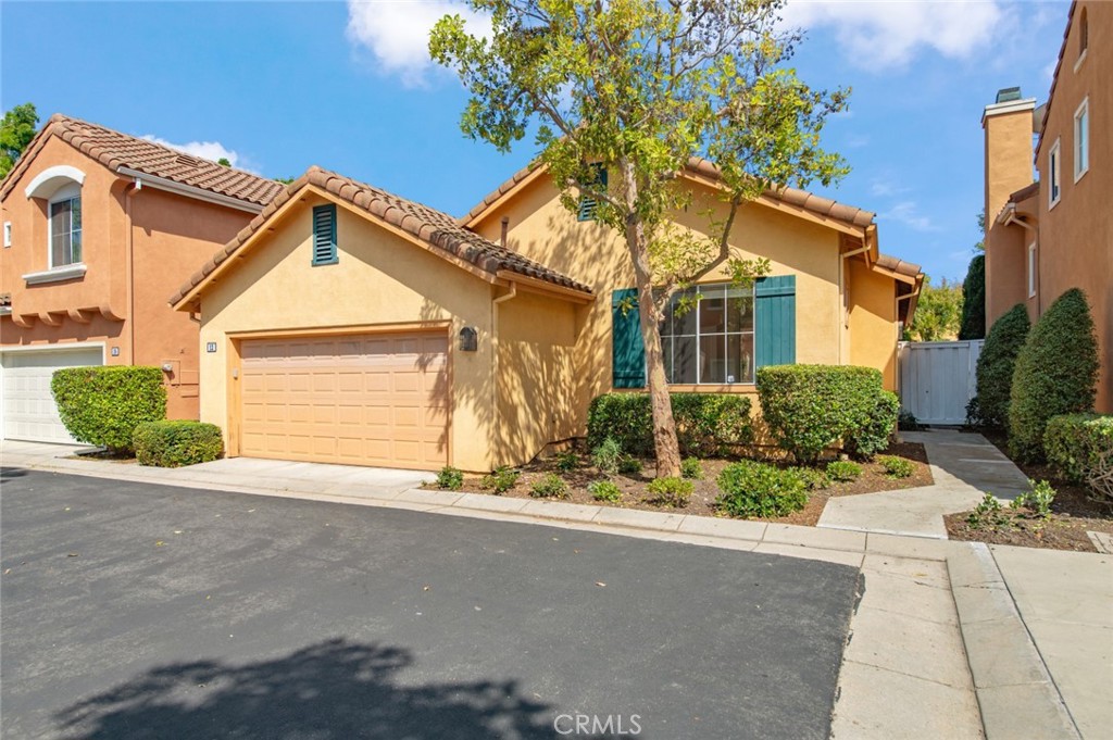 12 Parthenia Irvine, CA 92606 - Photo 2 of 25 a front view of a house with a yard and garage