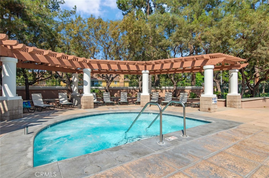 12 Parthenia Irvine, CA 92606 - Photo 23 of 25 a view of a patio with a table and chairs under an umbrella