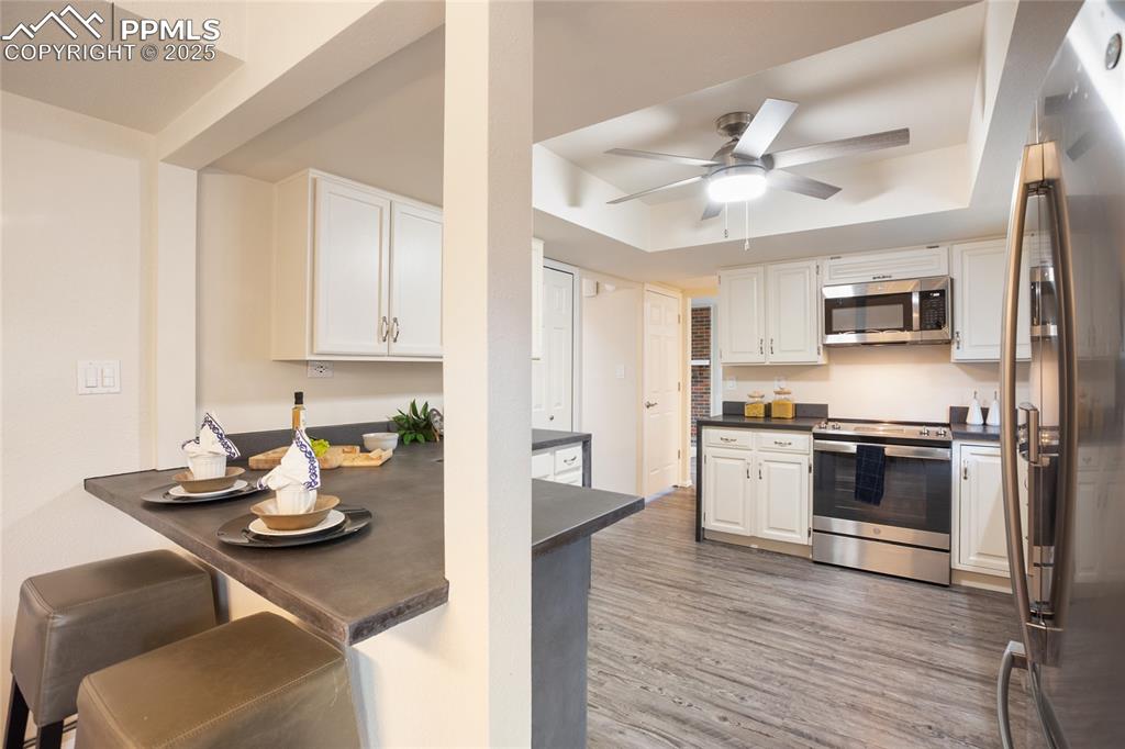 3004 Springlake Circle East Colorado Springs, CO 80906 - Photo 17 of 50 a kitchen with stainless steel appliances granite countertop a sink dishwasher stove top oven and refrigerator