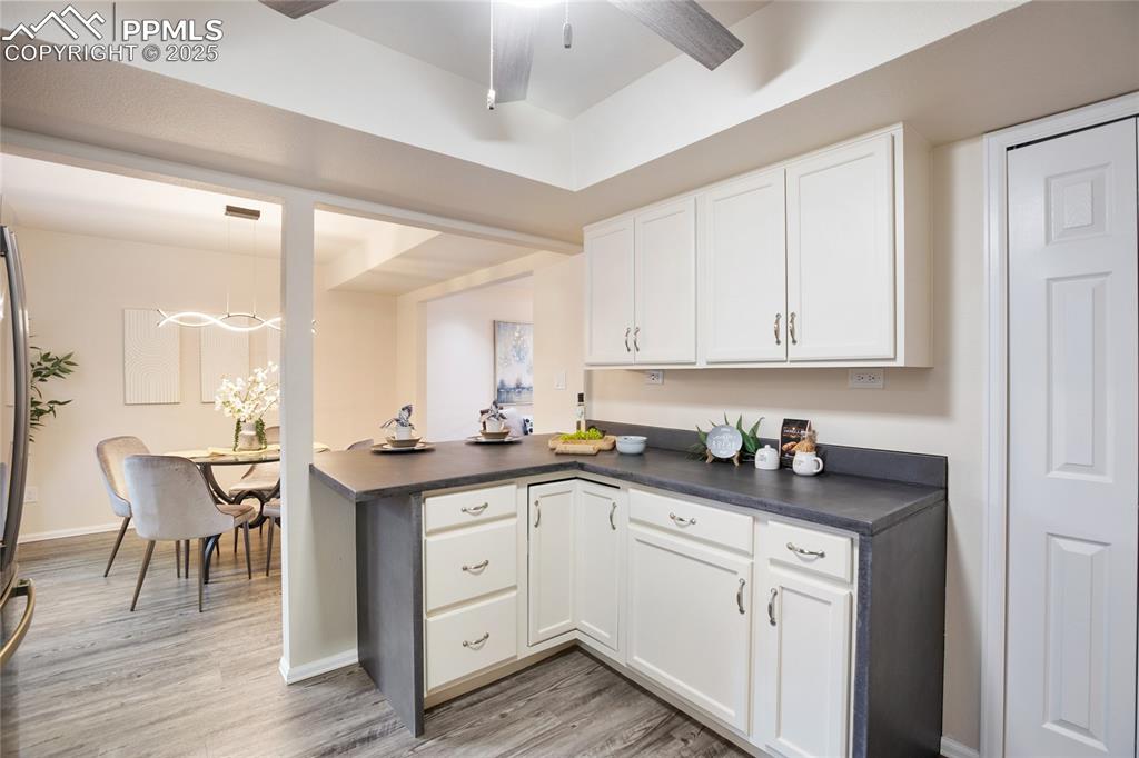 3004 Springlake Circle East Colorado Springs, CO 80906 - Photo 19 of 50 a kitchen with a sink cabinets and wooden floor