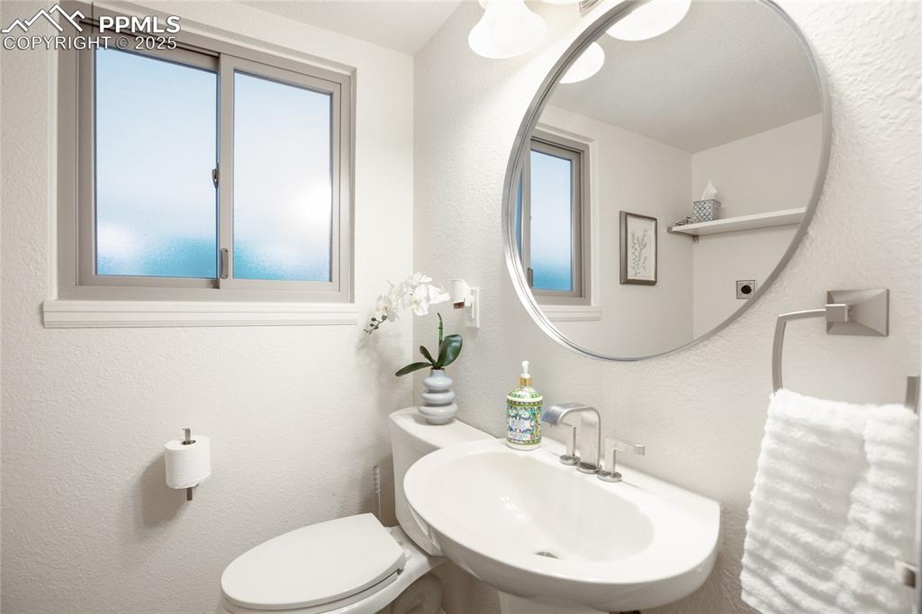 3004 Springlake Circle East Colorado Springs, CO 80906 - Photo 23 of 50 a bathroom with a toilet sink and mirror