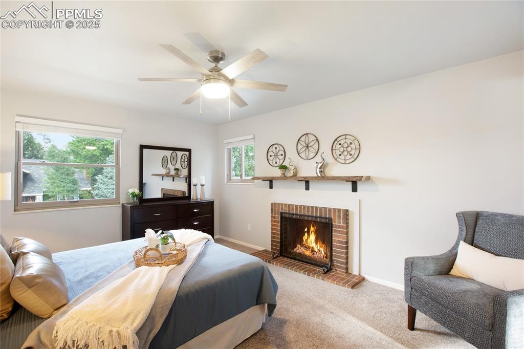 3004 Springlake Circle East Colorado Springs, CO 80906 - Photo 24 of 50 a bedroom with a bed and a fireplace